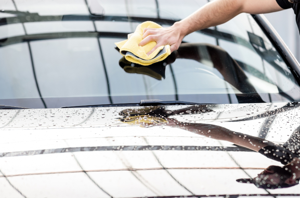 Technician inspecting windshield damage for repair Mobile windshield repair service being performed